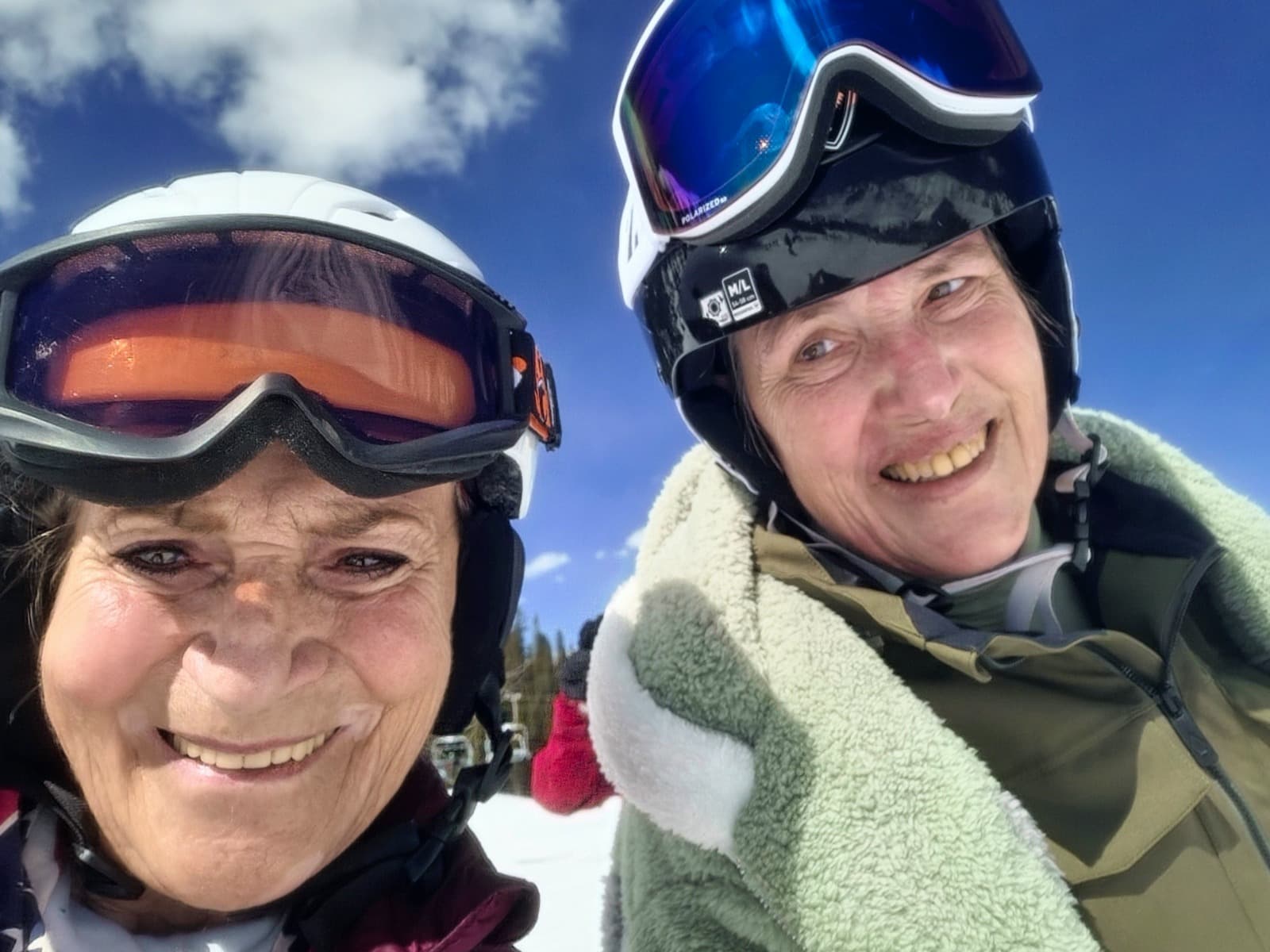 Vera Shury alpine skiing at 86 with client and colleague on mountain peak